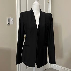 Black collarless blazer with single button closure